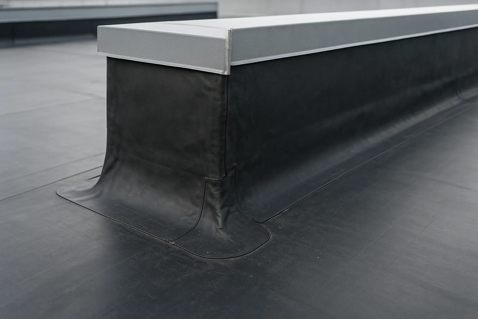 a close-up of EPDM rubber membrane and flashing details around a rooftop curb on a commercial building — commercial roofing